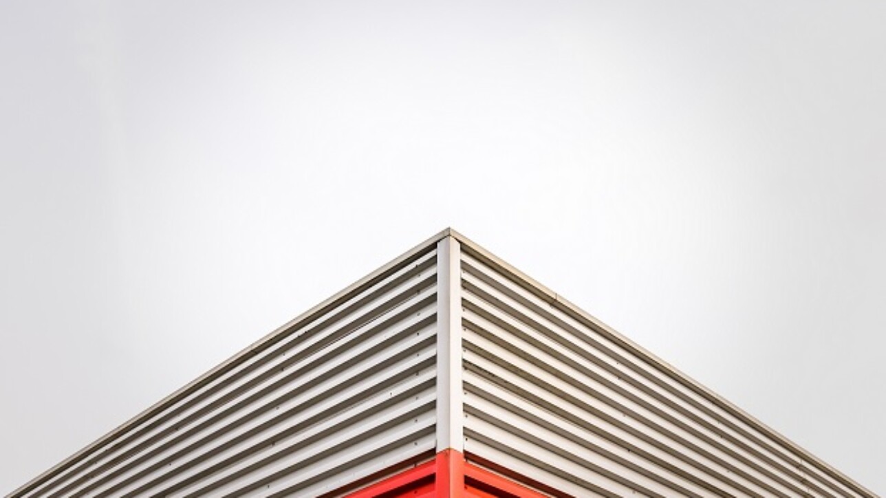 Abstract Architecture Detail Of A Factory Roof Corner Against An Overcast Sky With Copy Space